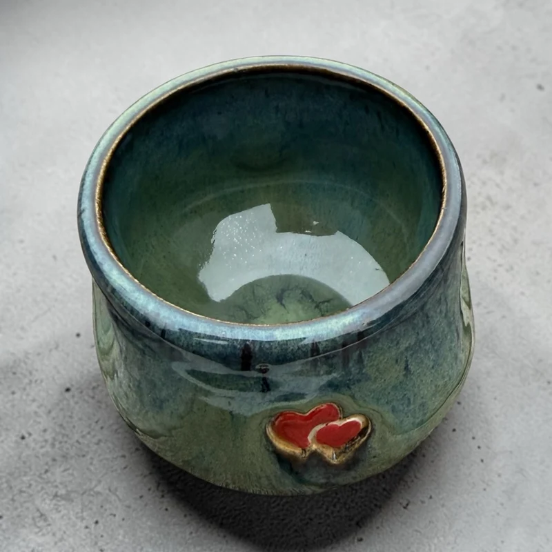 Handmade ceramic cup – green glaze with heart detail